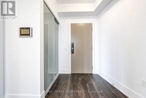 Toronto (Waterfront Communities) condo for rent - A hallway with a door and a wall-mounted thermostat.
