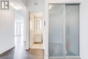 Toronto (Waterfront Communities) condo for rent - A white hallway with a glass door leading to a bedroom.