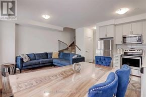 Vaughan (Vaughan Grove) townhouse for rent - A modern living room with a blue sofa and matching chairs.