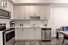 Vaughan (Vaughan Grove) townhouse for rent - A modern kitchen with white cabinets and stainless steel appliances.
