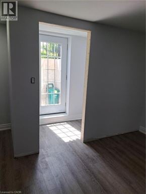 Burlington apartment for rent - A room with a door leading outside and a green bucket on the doorstep.