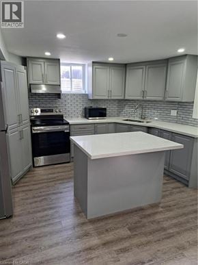 Burlington apartment for rent - A kitchen with a white island in the middle.