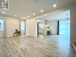 Collingwood apartment for rent - A spacious room with wooden flooring and a kitchen area in the background.