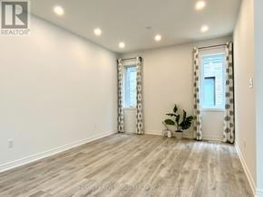 Collingwood apartment for rent - A room with wooden flooring and a window with curtains.