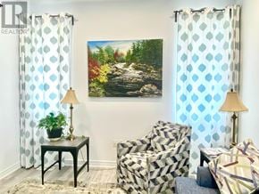 Collingwood apartment for rent - A living room with a painting of a forest scene on the wall.