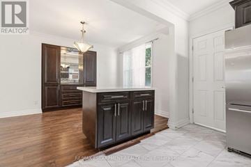 Hamilton (Crown Point) apartment for rent - A kitchen with dark wood cabinets and a white island.