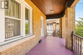 Hamilton (Crown Point) apartment for rent - A balcony with a wooden floor and a brick wall.