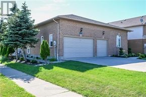 Hamilton (Stoney Creek) apartment for rent - A house with a garage door and a tree in front.