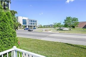Hamilton (Stoney Creek) apartment for rent - A view of a road with cars and a building in the background.