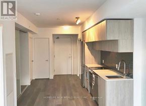 Toronto (Moss Park) condo for rent - A modern kitchen with a sink, stove, and cabinets.