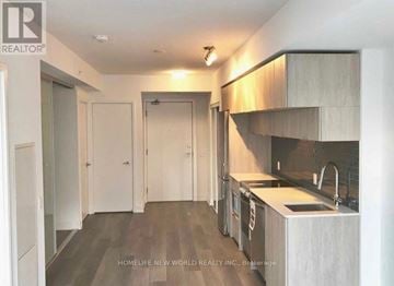 Toronto (Moss Park) condo for rent - A modern kitchen with a sink, stove, and cabinets.