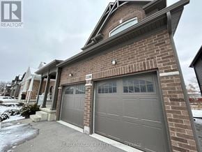 Fort Erie (Ridgeway) apartment for rent - A house with a grey garage door is for sale.