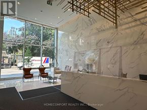 Toronto (Church-Yonge Corridor) condo for rent - A reception area with a marble counter and chairs.