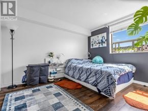 Toronto (Kensington-Chinatown) condo for rent - A bedroom with a bed, a nightstand, and a window with a view.