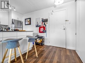 Toronto (Kensington-Chinatown) condo for rent - A kitchen with a bar stool and a dining table.