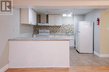Pickering (Amberlea) apartment for rent - A kitchen with a white fridge and a counter top.