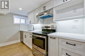 Oakville (Co Central) apartment for rent - A kitchen with white cabinets and a stainless steel oven.