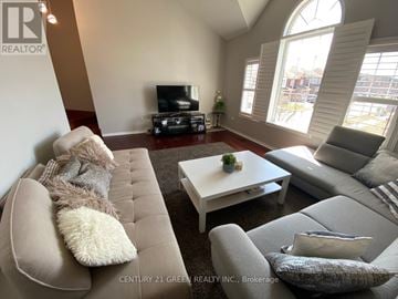 Mississauga (Churchill Meadows) apartment for rent - A living room with a grey couch and a white coffee table.