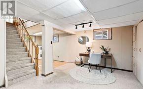 Oshawa (Mclaughlin) apartment for rent - A room with a staircase, desk, and chair.