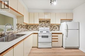 Toronto (Long Branch) condo for rent - A kitchen with a white oven and refrigerator.