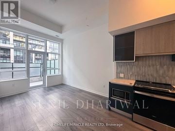 Oakville (Go Glenorchy) condo for rent - A real estate listing image of a kitchen with a stove top oven and a microwave.