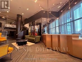 Oakville (Go Glenorchy) condo for rent - A reception area with a brown floor and a large window.
