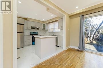 Toronto (Kingsview Village-The Westway) apartment for rent - A kitchen with a white counter top and wooden floors.