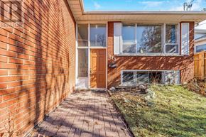 Toronto (Kingsview Village-The Westway) apartment for rent - A brick house with a brown door and windows.