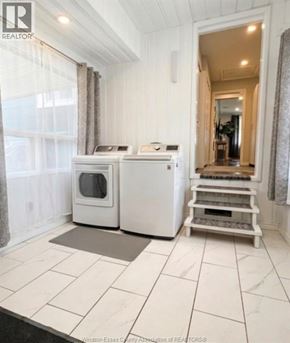 Lakeshore apartment for rent - A white kitchen with a microwave and oven.