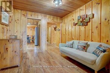 Kawartha Lakes (Fenelon) apartment for rent - A cozy living room with a couch and wooden walls.