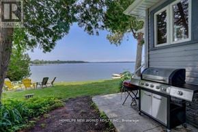 Kawartha Lakes (Fenelon) apartment for rent - A backyard with a grill and chairs overlooking a lake.