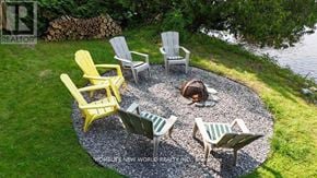 Kawartha Lakes (Fenelon) apartment for rent - A set of four chairs and a table are arranged in a circle on a gravel patio.