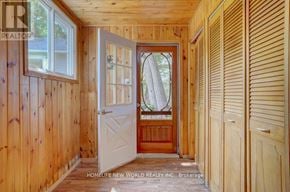 Kawartha Lakes (Fenelon) apartment for rent - A wooden hallway with a white door and a window.