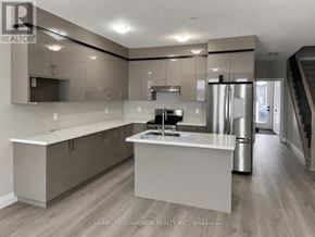Welland (Lincoln/Crowland) townhouse for rent - A modern kitchen with a central island and stainless steel appliances.