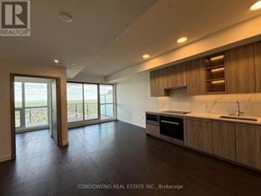 Toronto (Bayview Village) condo for rent - A modern kitchen with wooden cabinets and a marble countertop.
