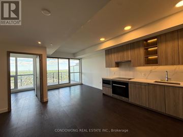 Toronto (Bayview Village) condo for rent - A modern kitchen with wooden cabinets and a marble countertop.