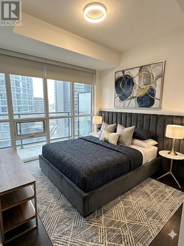 Toronto (Lansing-Westgate) condo for rent - A bedroom with a large bed and a painting on the wall.