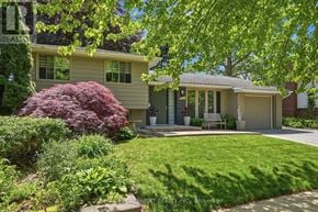 Burlington (Roseland) apartment for rent - A house with a green lawn and a red bush in front.