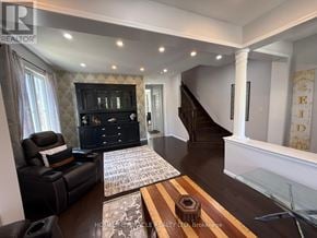 Cambridge apartment for rent - A living room with a black leather couch and a wooden coffee table.