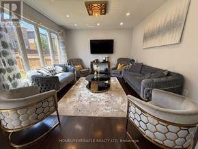 Cambridge apartment for rent - A living room with a grey couch, a coffee table, and a television.