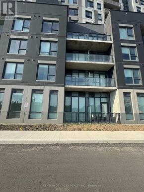 Kitchener condo for rent - A modern apartment building with balconies and glass doors.