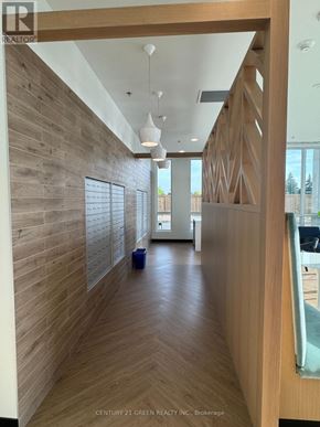 Kitchener condo for rent - A hallway with wood paneling and a white ceiling.
