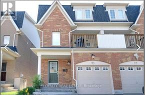 Whitby (Pringle Creek) townhouse for rent - A house with a brick facade and a balcony with a railing.