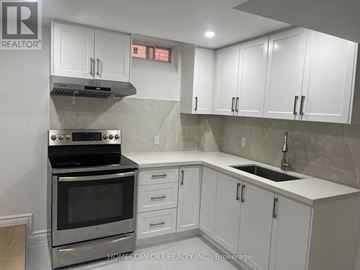 Richmond Hill (Devonsleigh) apartment for rent - A kitchen with white cabinets and a stainless steel oven.