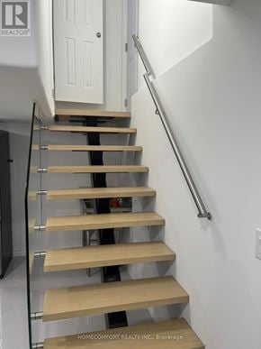 Richmond Hill (Devonsleigh) apartment for rent - A staircase with wooden steps and a metal handrail.