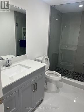 Richmond Hill (Devonsleigh) apartment for rent - A white toilet is in a bathroom with a sink and mirror.