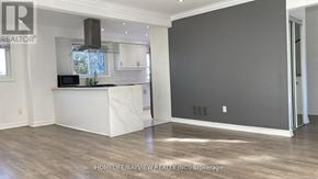 Newmarket (Central Newmarket) apartment for rent - A spacious kitchen with white cabinets and a marble island.