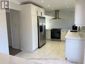 Newmarket (Central Newmarket) apartment for rent - A kitchen with white cabinets and appliances.