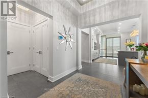 Burlington (Brant) condo for rent - A spacious white hallway with a rug and a star decoration on the wall.