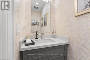 Burlington (Brant) condo for rent - A bathroom with a sink, mirror, and a bottle of soap.